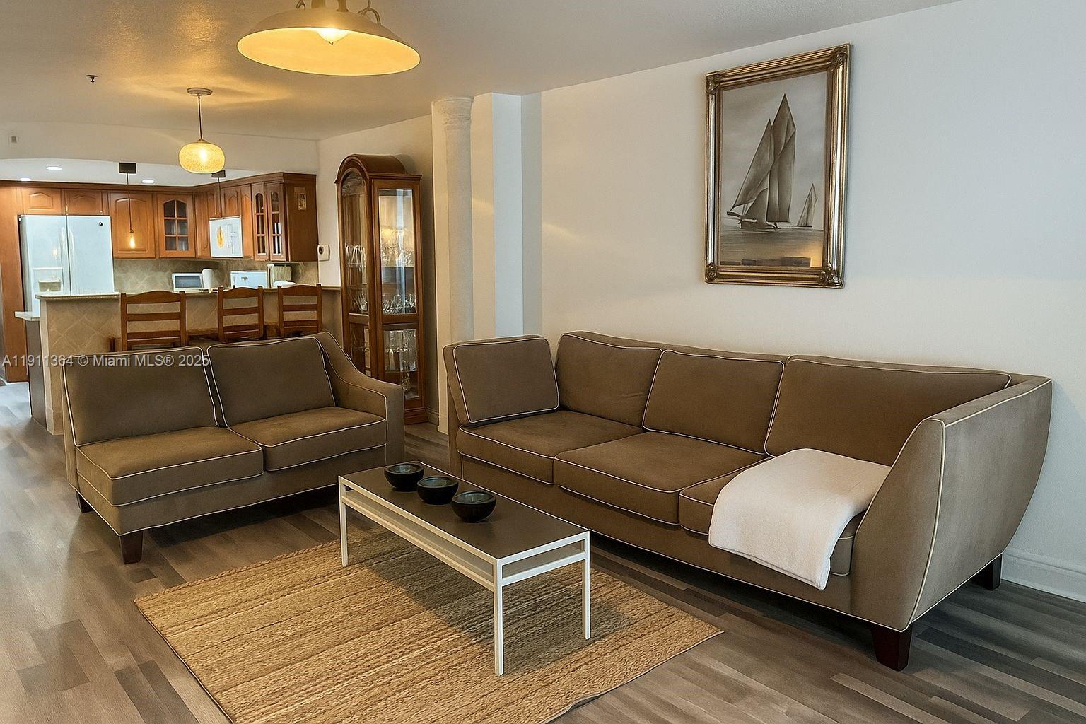 6345 Collins Avenue, Unit TH2 Miami Beach, FL 33141 - Photo 2 of 8 a living room with furniture and a wooden floor