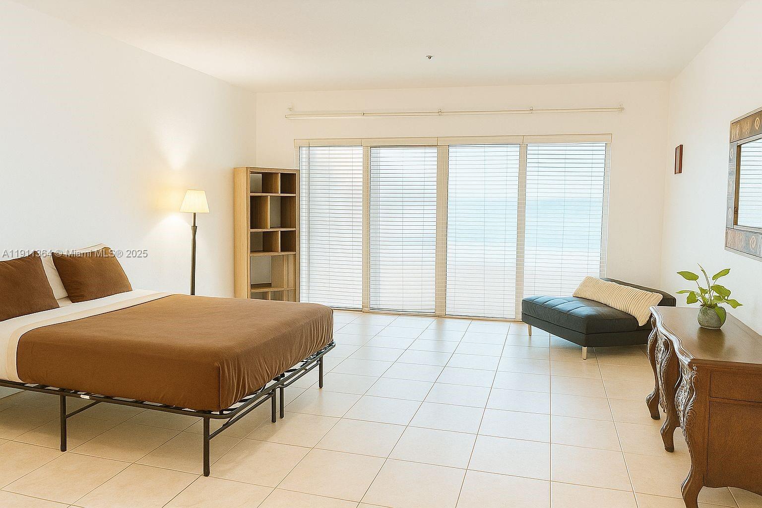 6345 Collins Avenue, Unit TH2 Miami Beach, FL 33141 - Photo 5 of 8 a living room with a bed and furniture