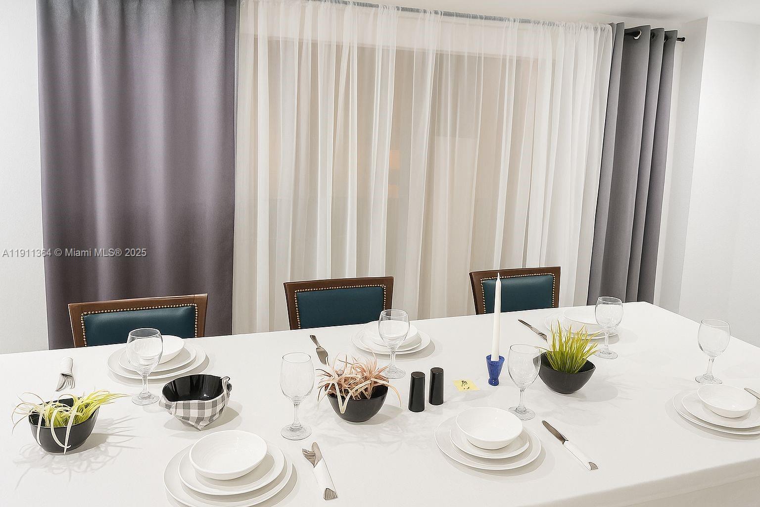 6345 Collins Avenue, Unit TH2 Miami Beach, FL 33141 - Photo 8 of 8 a close view of dining table and chairs