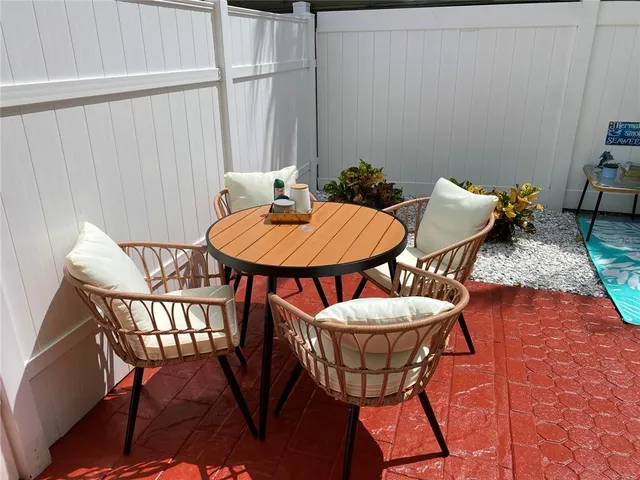 a wooden bench sitting in the backyard of a house