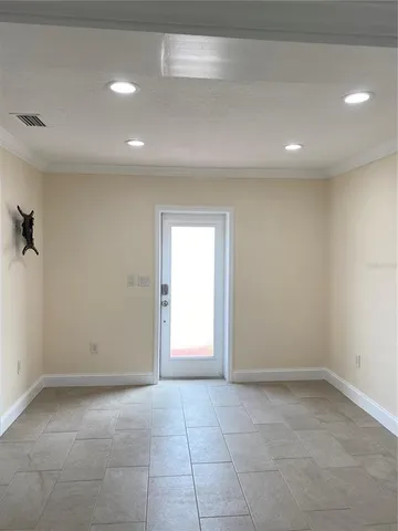 a view of an empty room with a window