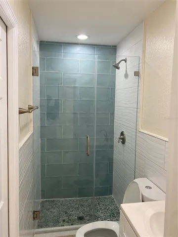 a bathroom with a shower and a sink