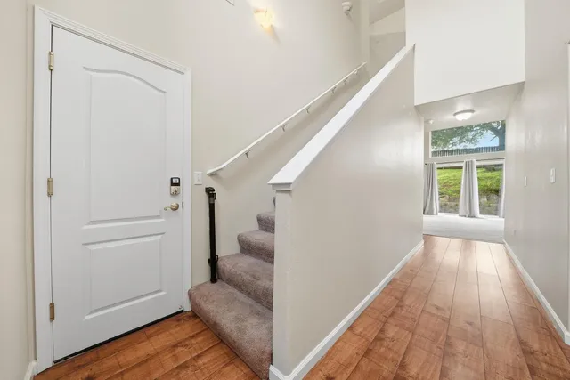 a view of a hallway with wooden floor and entryway