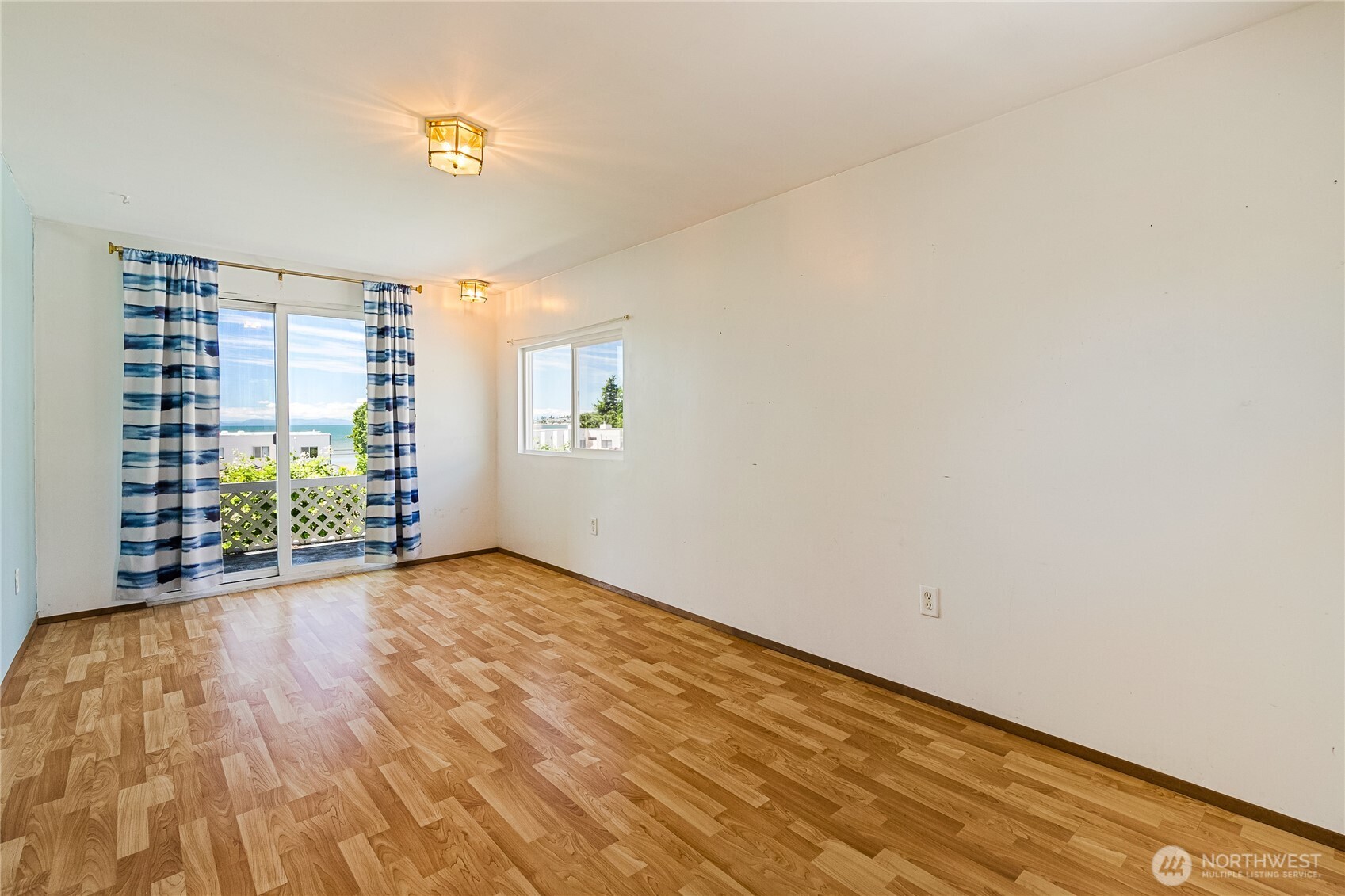 8080 Harborview Road, Unit 167 Blaine, WA 98230 - Photo 6 of 27 a view of an empty room with a window and wooden floor
