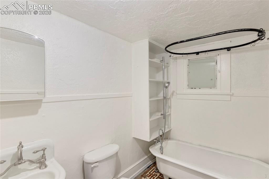2620 Main Street Colorado Springs, CO 80907 - Photo 19 of 28 a bathroom with a toilet and a shower
