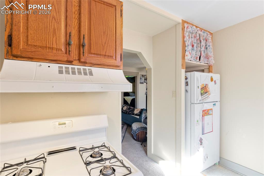 2620 Main Street Colorado Springs, CO 80907 - Photo 5 of 28 a kitchen with a refrigerator and cabinets