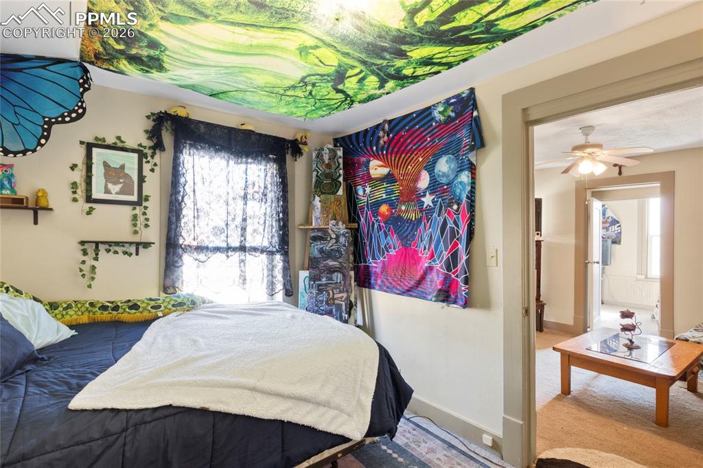 2620 Main Street Colorado Springs, CO 80907 - Photo 6 of 28 a bed sitting in a bedroom next to a window