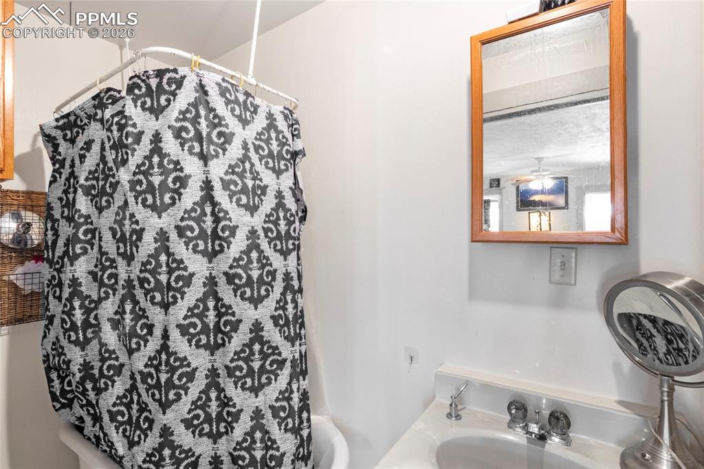 2620 Main Street Colorado Springs, CO 80907 - Photo 7 of 28 a bathroom with a bathtub and a sink
