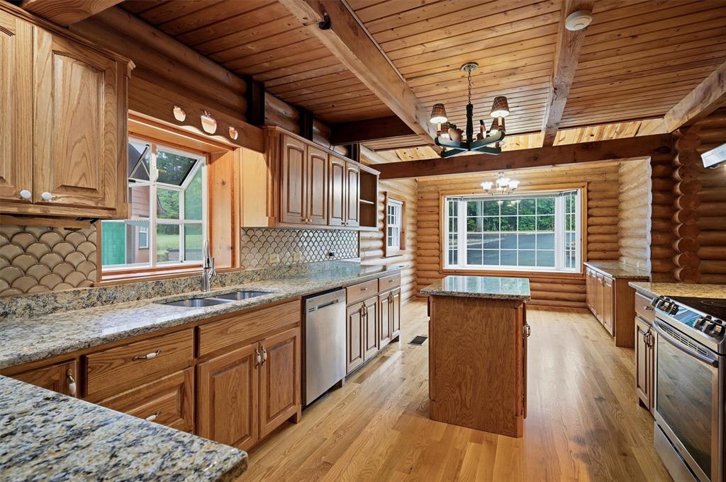 570 Ayres Road Bells, TX 75414 - Photo 14 of 40 a kitchen with stainless steel appliances granite countertop wooden floors and sink