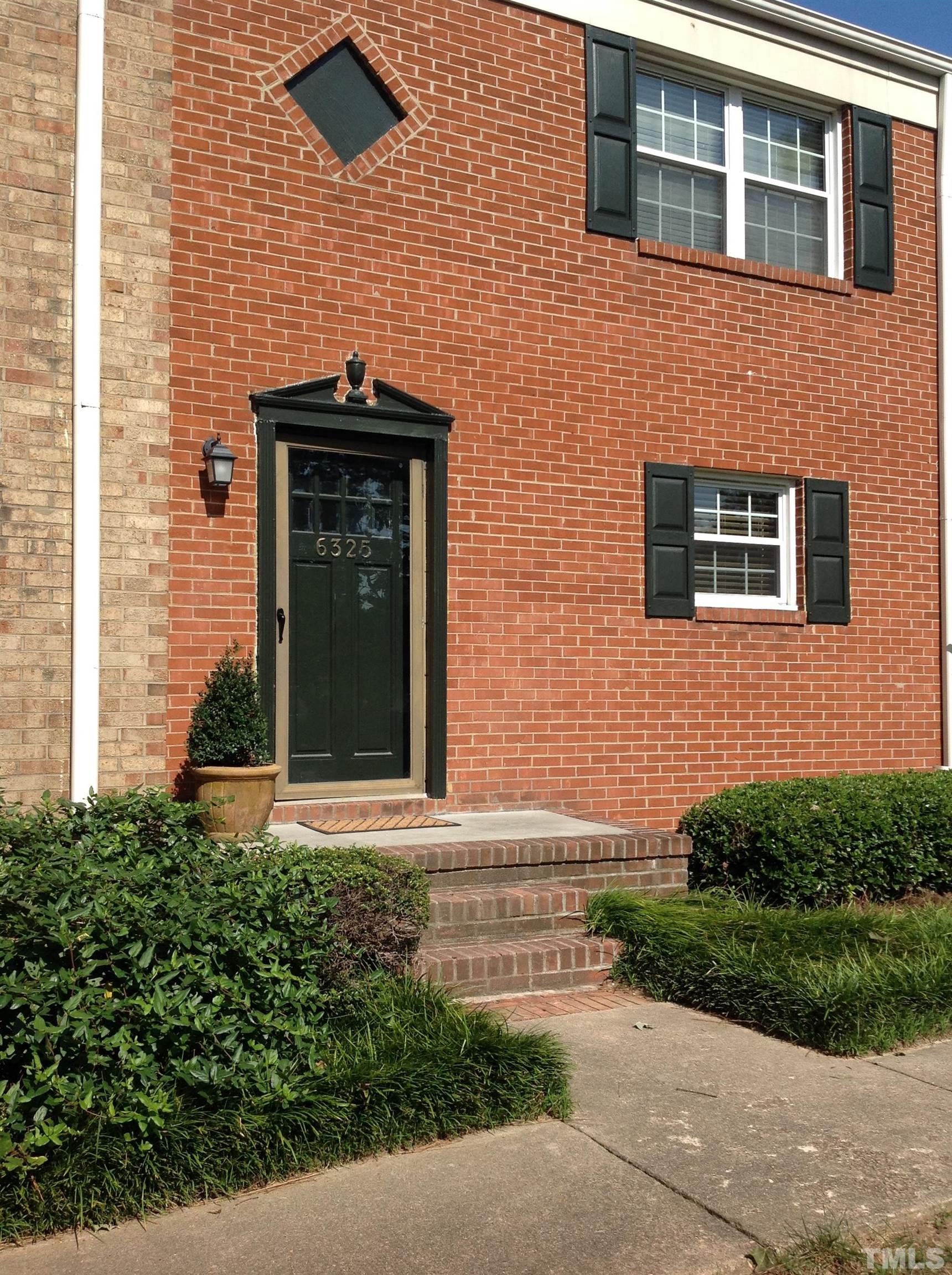 6325 New Market Way, Unit 6325 Raleigh, NC 27615 - Photo 2 of 13 a front view of a house with a yard and garage