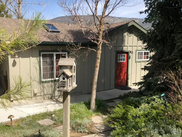 a view of a house with a yard and chair