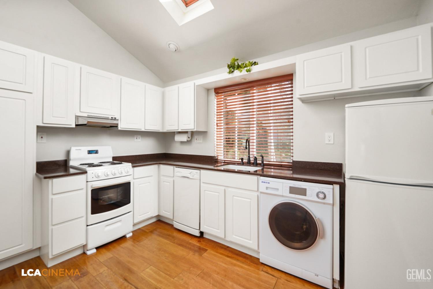 Undisclosed Address Tehachapi, CA 93561 - Photo 26 of 36 a kitchen with a stove top oven sink and cabinets