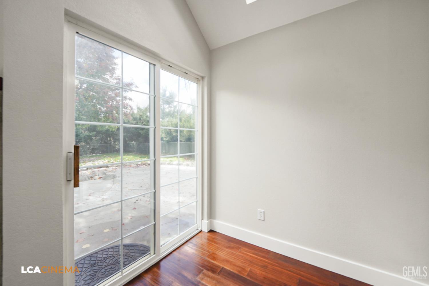 Undisclosed Address Tehachapi, CA 93561 - Photo 9 of 36 an empty room with wooden floor and windows
