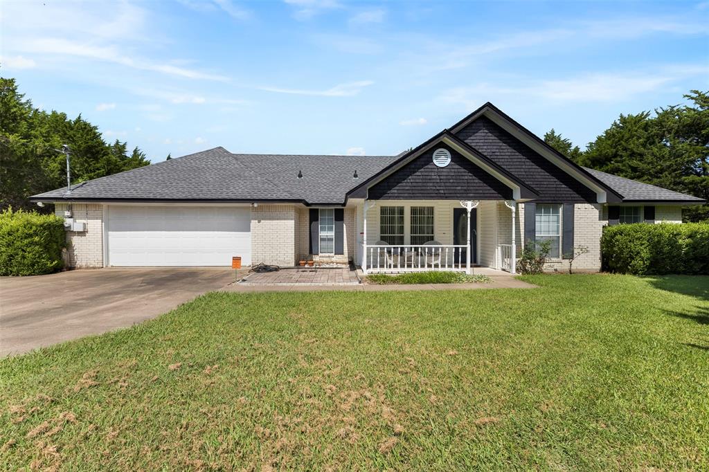 401 Rugged Drive Red Oak, TX 75154 - Photo 7 of 40 Ranch-style residence featuring a white brick facade, dark gray shingle roof, and a covered front porch with white railings