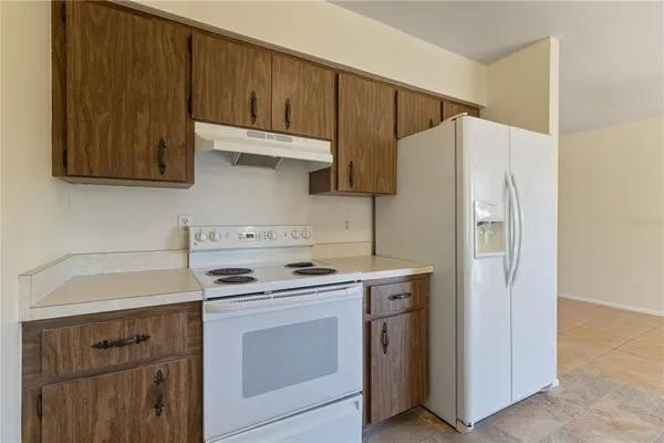 a kitchen with a sink a stove a refrigerator and cabinets