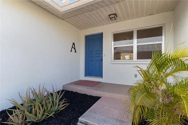 a bedroom with a bed and a potted plant