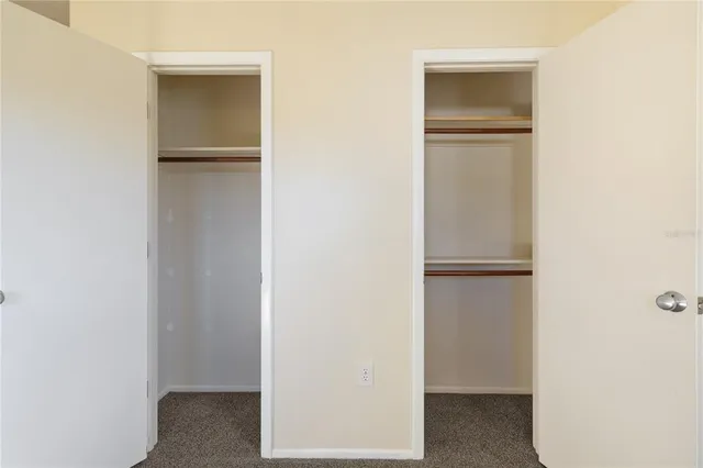 a view of walk in closet with empty racks