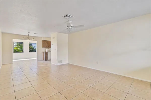 a view of a kitchen with a sink and a refrigerator