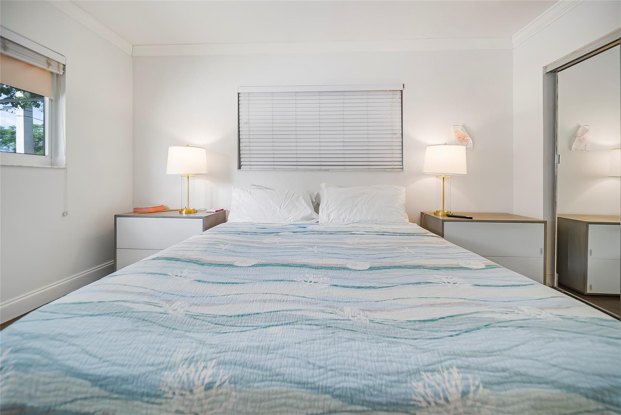 Undisclosed Address Deerfield Beach, FL 33441 - Photo 20 of 26 a bedroom with a bed and a night stand