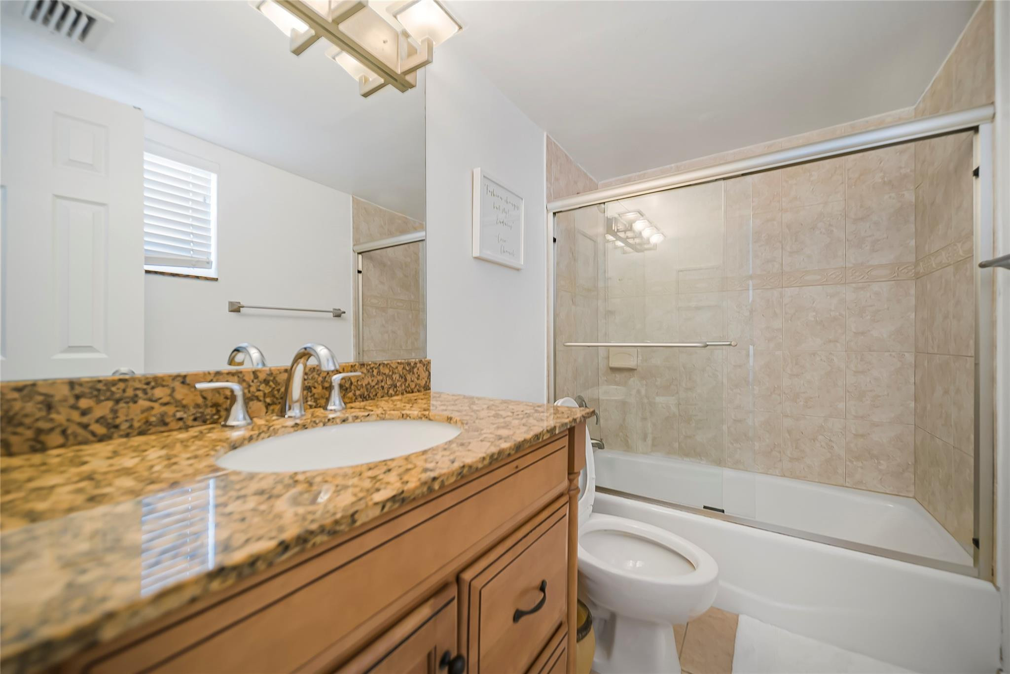 Undisclosed Address Deerfield Beach, FL 33441 - Photo 22 of 26 a bathroom with a granite countertop sink toilet and shower