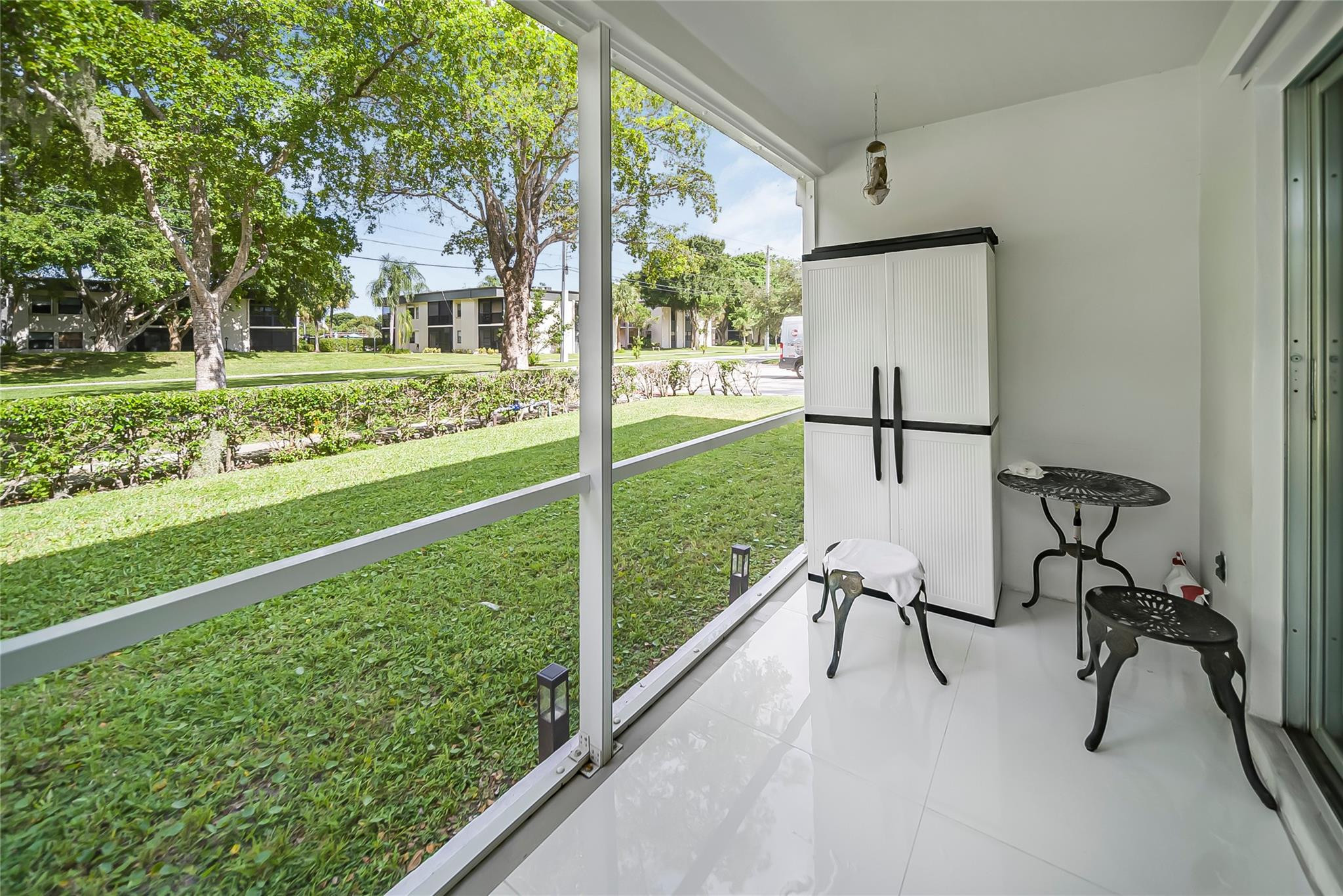 Undisclosed Address Deerfield Beach, FL 33441 - Photo 5 of 26 a view of a porch with chairs and a yard
