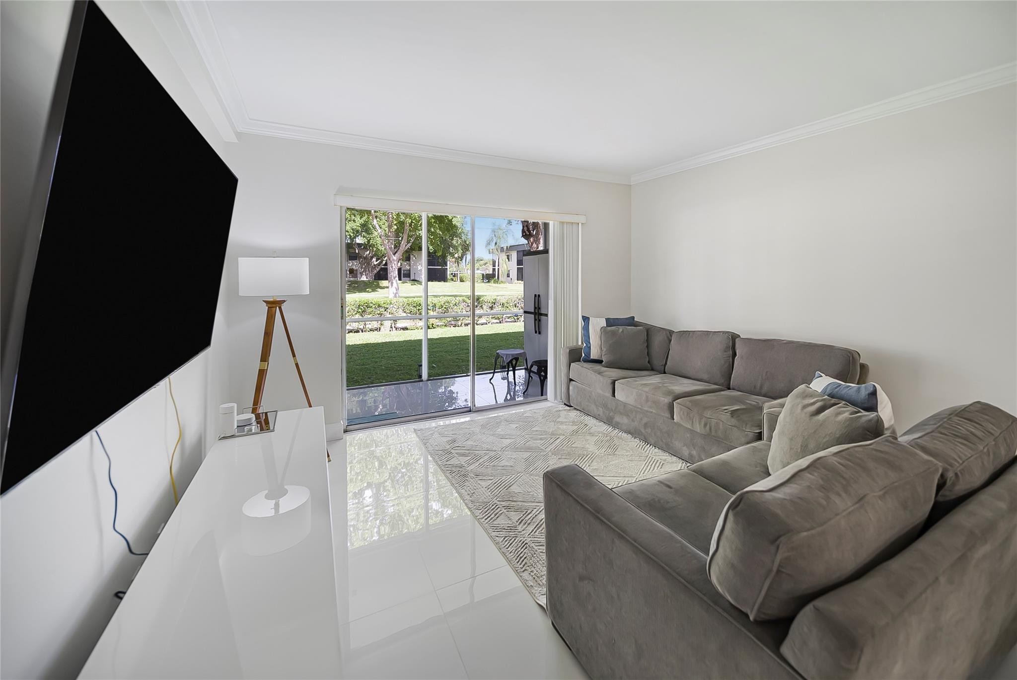 Undisclosed Address Deerfield Beach, FL 33441 - Photo 10 of 26 a living room with furniture and a flat screen tv