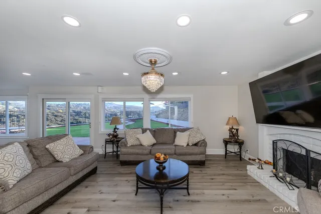 a living room with furniture a fireplace and a flat screen tv