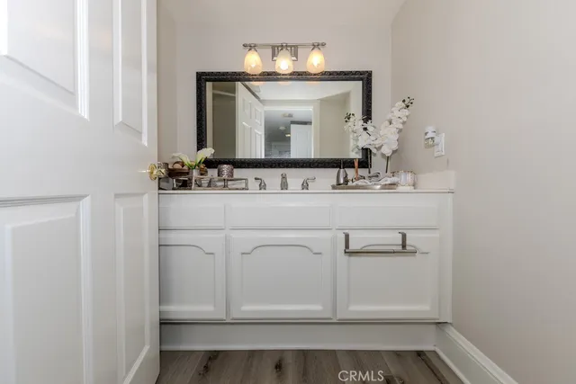 a bathroom with a sink vanity and mirror