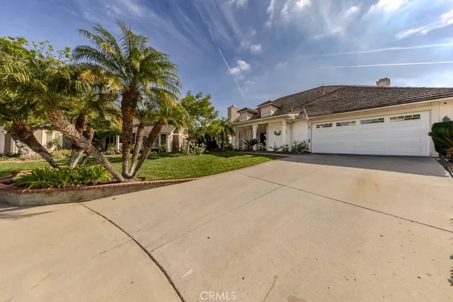 a front view of a house with a yard and a garage