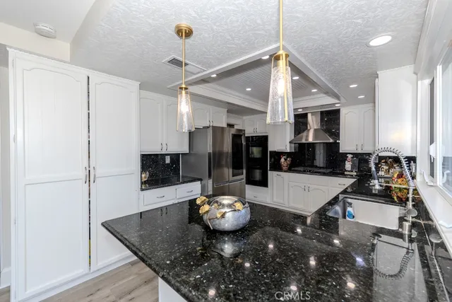 a large kitchen with a table and chairs