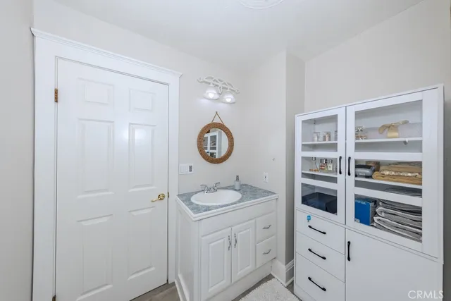 a bathroom with a granite countertop sink vanity and a mirror