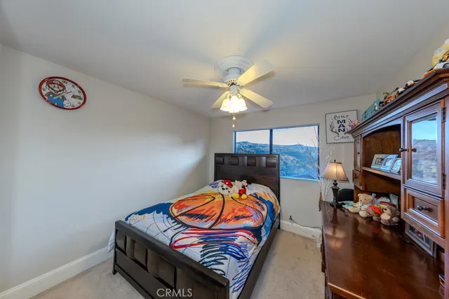 a bedroom with furniture and a flat screen tv