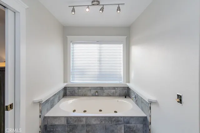 a spacious bathroom with a double vanity sink and a mirror