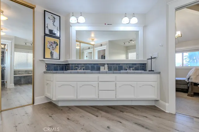 a bathroom with a double vanity sink and mirror