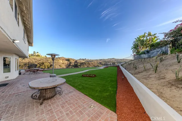 a view of a backyard with potted plants