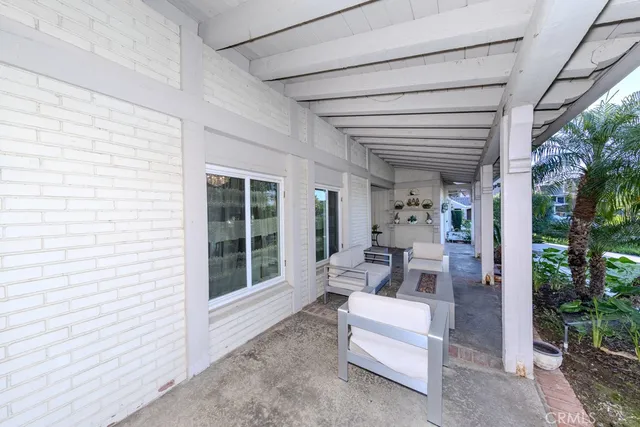 a view of house with backyard and sitting area