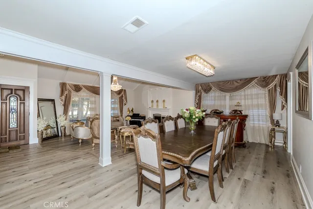 a dining room with furniture and wooden floor