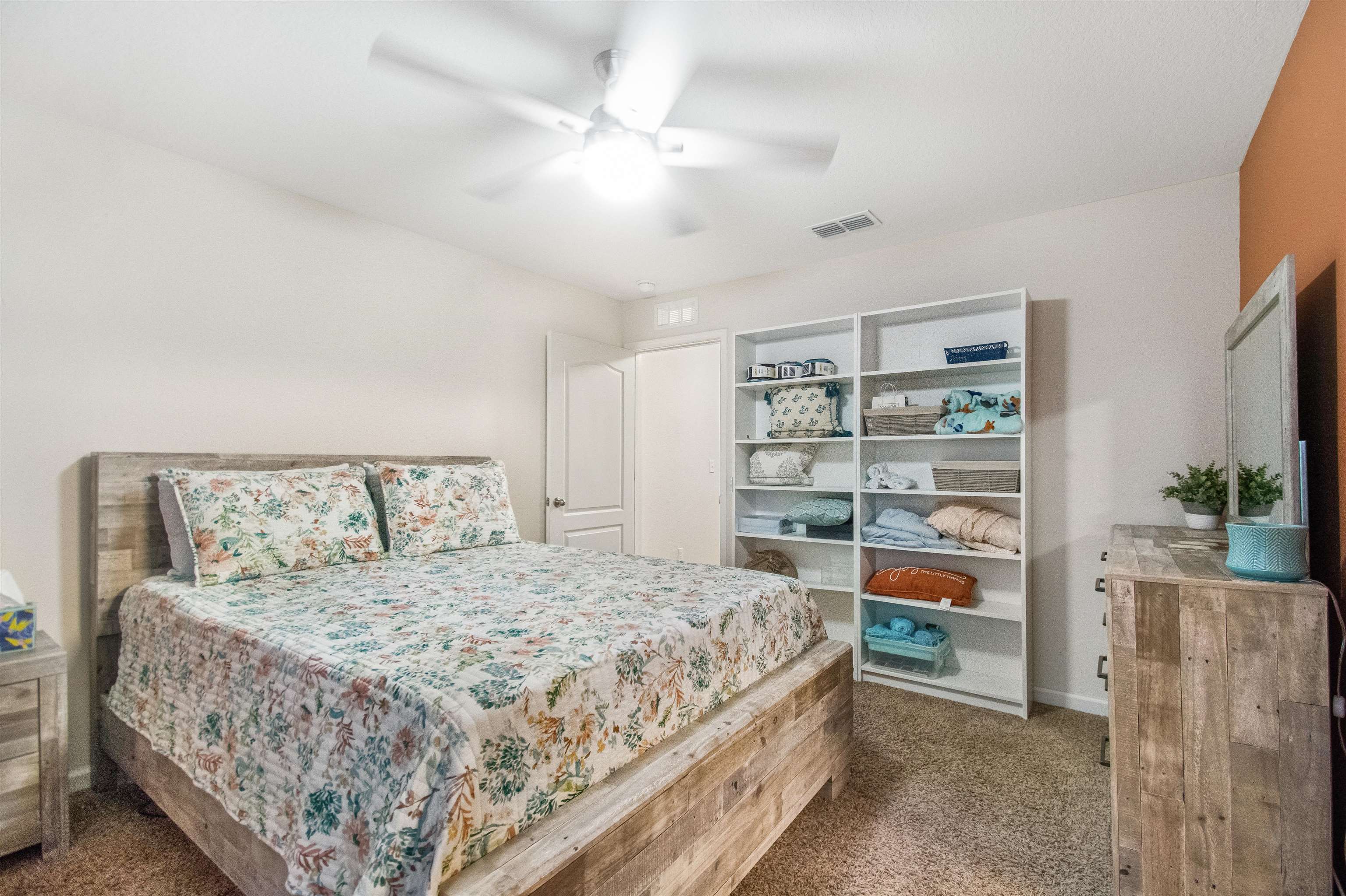 39 Whitland Way St. Augustine, FL 32086 - Photo 14 of 29 a bedroom with a large bed and a chandelier