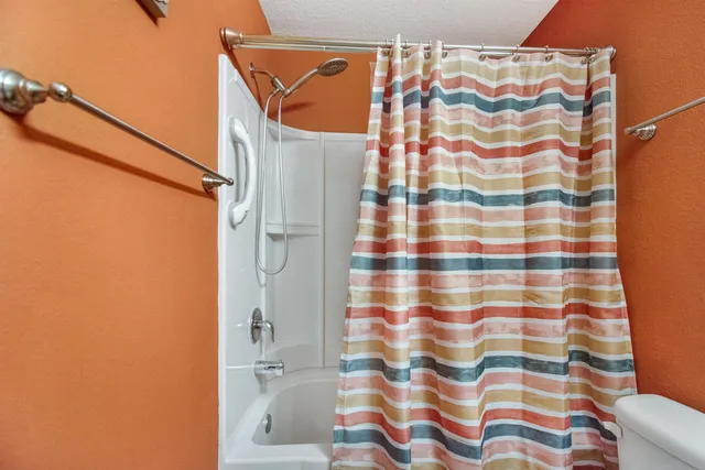 a bathroom with a shower curtain and a sink