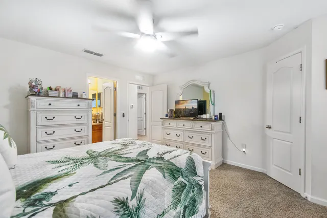 a bedroom with a bed and a dresser