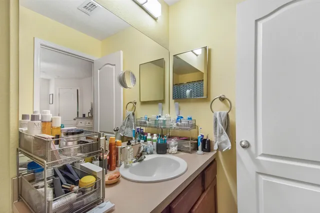 a bathroom with a sink mirror and vanity