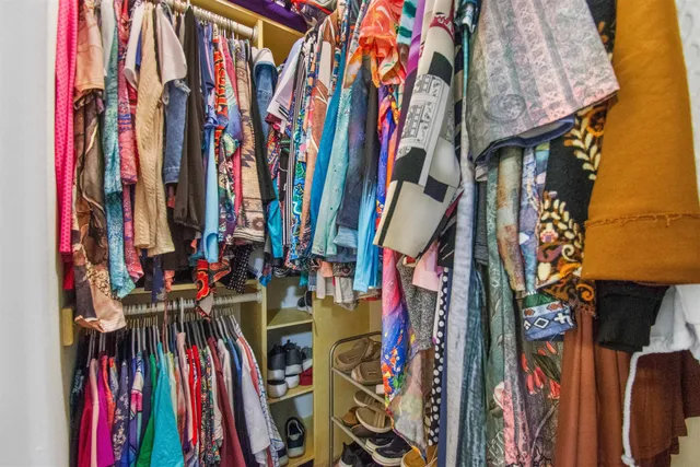 a view of walk in closet with clothes