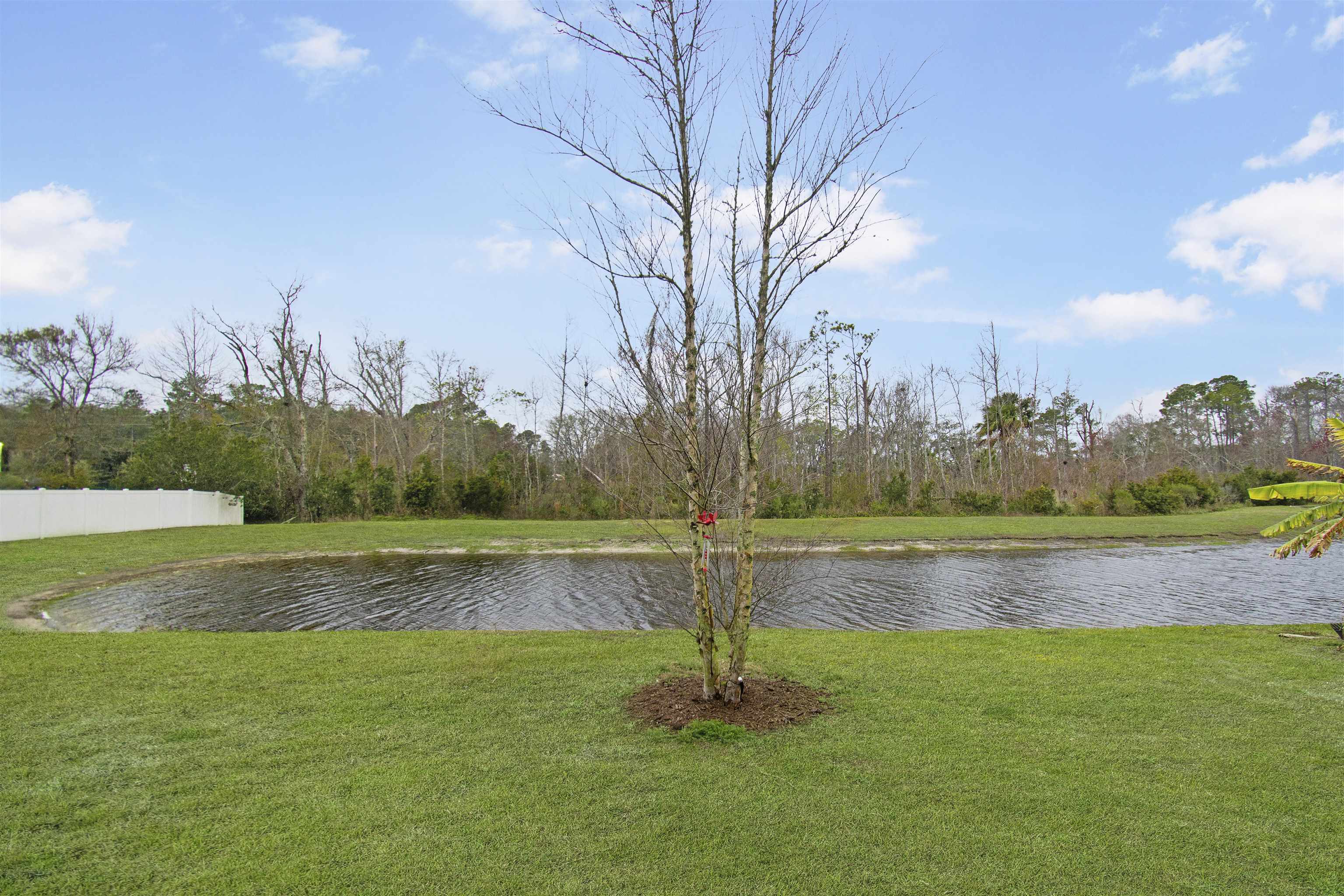 39 Whitland Way St. Augustine, FL 32086 - Photo 28 of 29 a view of a lake with houses in the back