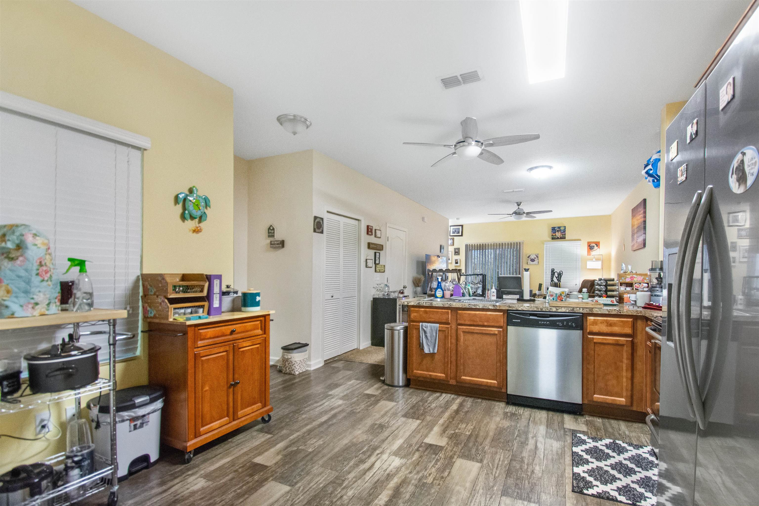39 Whitland Way St. Augustine, FL 32086 - Photo 4 of 29 a kitchen with stainless steel appliances granite countertop a refrigerator a stove top oven a sink dishwasher and white cabinets with wooden floor