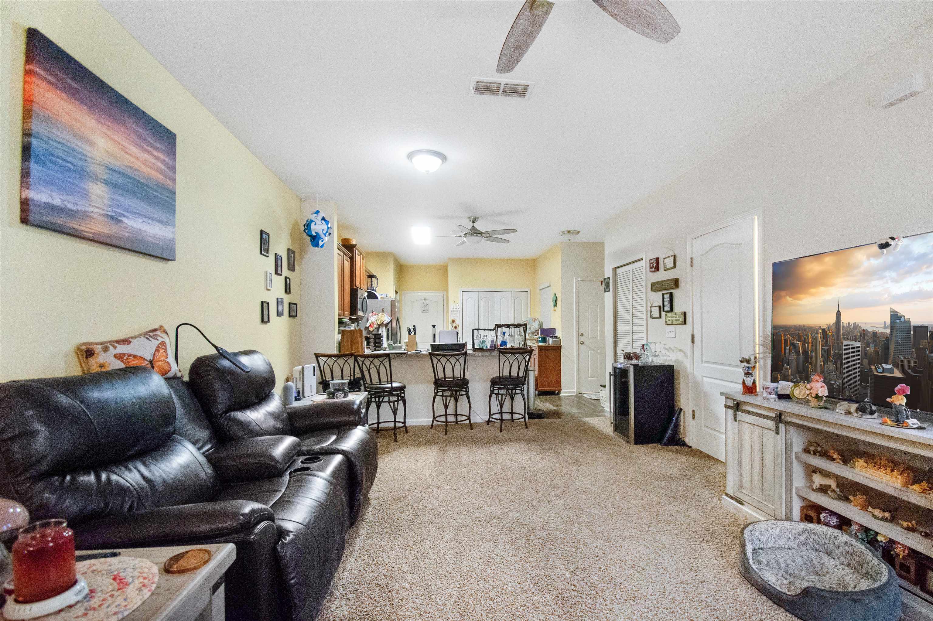 39 Whitland Way St. Augustine, FL 32086 - Photo 10 of 29 a living room with furniture and a dining table with kitchen view