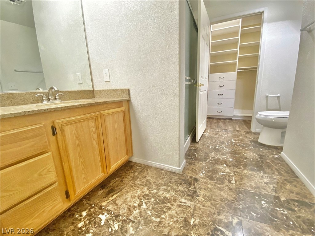 10550 West Alexander Road, Unit 1131 Las Vegas, NV 89129 - Photo 13 of 18 A well-appointed bath features a spacious vanity with an integrated walk-in closet.
