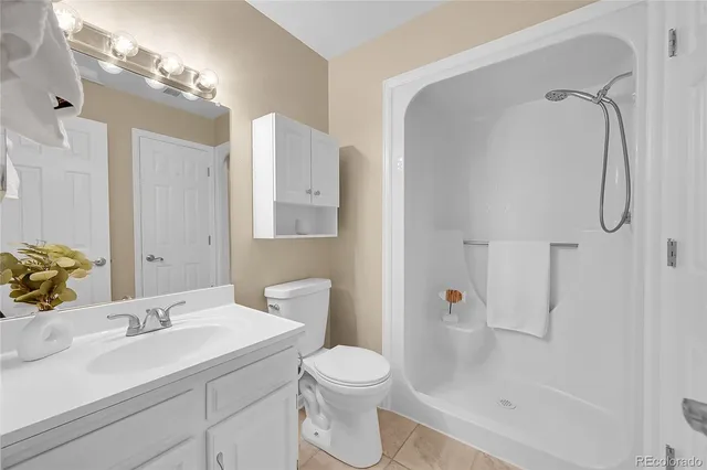 a bathroom with a sink toilet vanity and shower