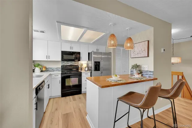 a kitchen with a stove a sink and a refrigerator