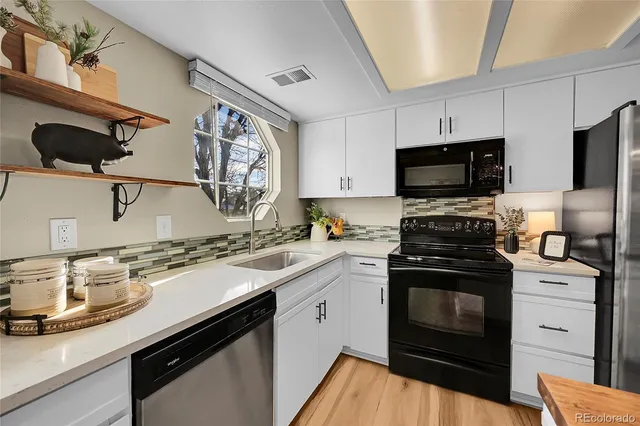 a kitchen with a sink stove and microwave