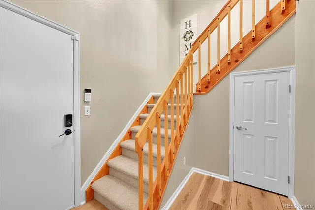 a view of staircase with wooden floor and stairs